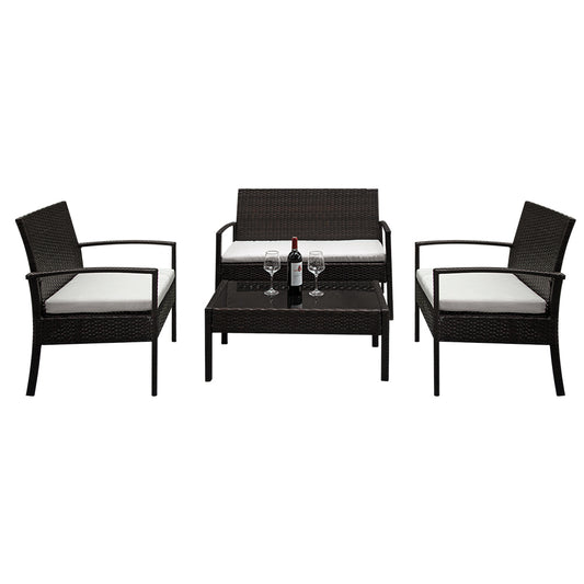 Brown wicker garden seating set with off-white cushions, includes loveseat, chair, and black glass table