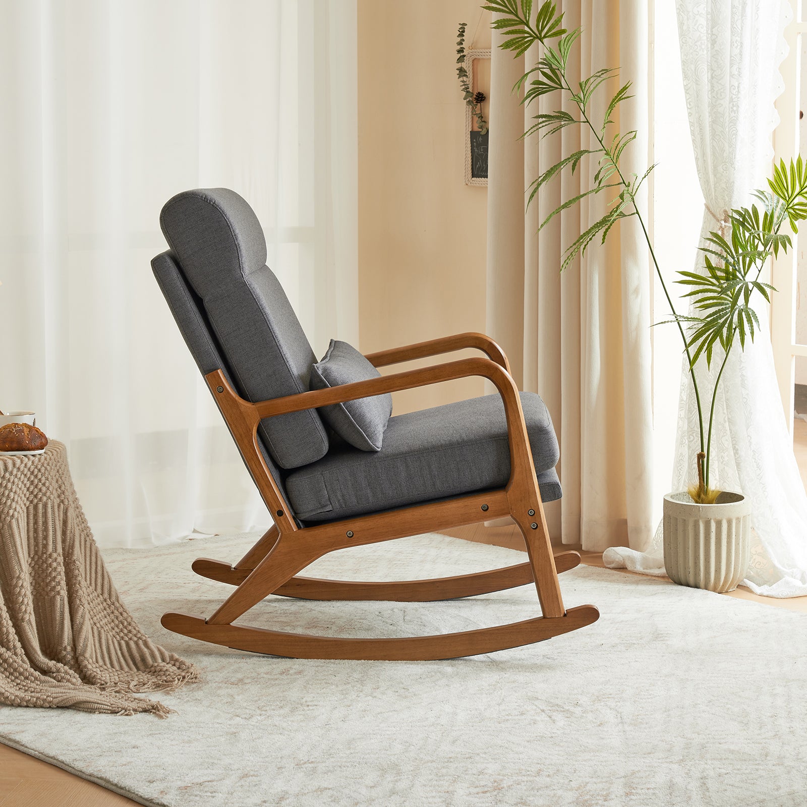 Side view of the grey linen indoor rocking chair, displaying its stylish and ergonomic design.